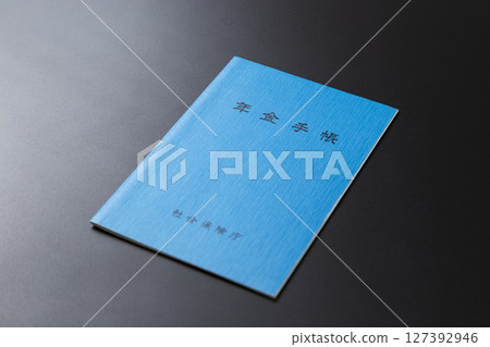 Pension book on a black background 127392946