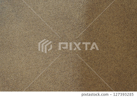 Wet sand on the beach top down view, backdrop. Sandy background Wet sand on the beach top down view, backdrop. Sandy background 127393285
