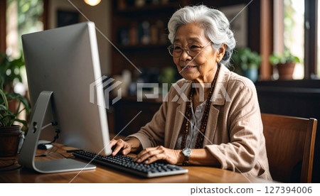 Senior woman working on a computer (AI generated image) 127394006
