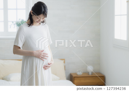 pregnant woman in the living room 127394236
