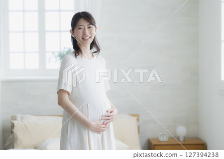 pregnant woman in the living room 127394238