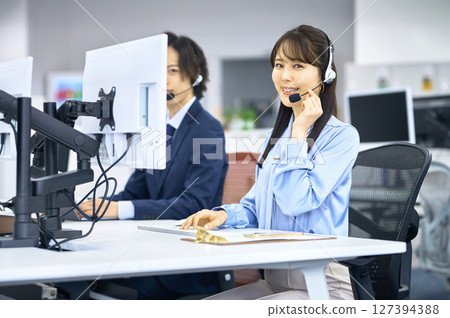 Smiling young female operator working in the office 127394388