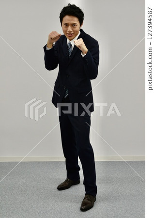 young man in fighting pose young man in fighting pose 127394587