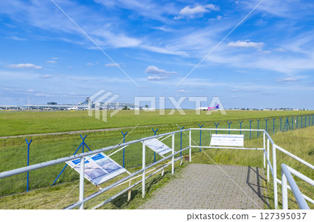 Airplane taxiing at Vaclav Havel Airport Prague with information panels in the foreground Airplane taxiing at Vaclav Havel Airport Prague with information panels in the foreground 127395037