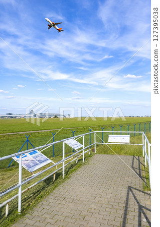 Airplane taking off over Vaclav Havel Airport Prague, viewed from plane spotting platform in Hostivice, Czechia 127395038