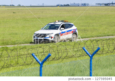 Airport Security Car Patrolling near Barbed Wire Fence at Vaclav Havel Airport Prague, Czechia 127395045