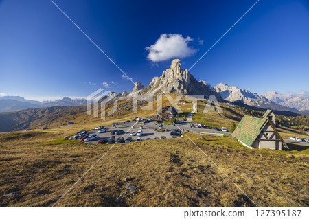 Passo Giau parking area with chapel and Nuvolau group dominating the landscape in Dolomites, Italy Passo Giau parking area with chapel and Nuvolau group dominating the landscape in Dolomites, Italy 127395187