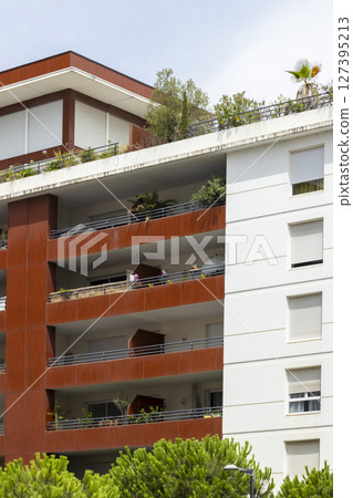 Modern apartment building with balconies and rooftop garden in Montpellier, France Modern apartment building with balconies and rooftop garden in Montpellier, France 127395213