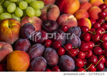 Fresh peaches, plums, cherries and grapes creating a colorful summer fruit composition Fresh peaches, plums, cherries and grapes creating a colorful summer fruit composition 127395223