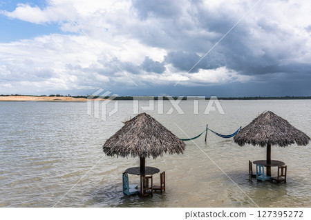 Straw huts on the banks of the Torta Lagoon, Tatajuba Beach at Jijoca de Jericoacoara, Ceara in Brazil Straw huts on the banks of the Torta Lagoon, Tatajuba Beach at Jijoca de Jericoacoara, Ceara in Brazil 127395272