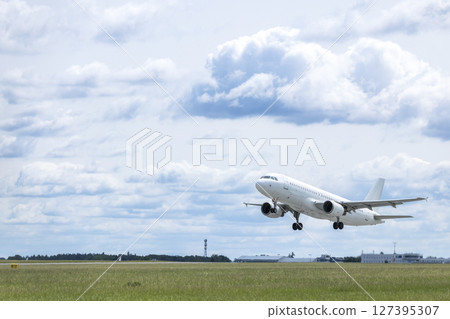 White passenger airplane taking off from Airport Prague, Czechia 127395307