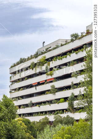 Modern building with many balconies and plants growing in Montpellier, France 127395318