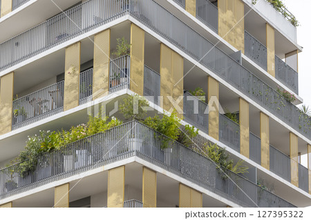 Modern building facade with balconies and plants growing in Montpellier, France Modern building facade with balconies and plants growing in Montpellier, France 127395322
