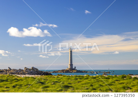 Phare de la Hague lighthouse standing on rocky islet in Normandy, France 127395350