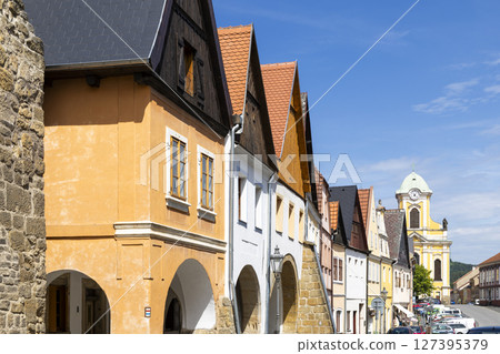 Colorful houses lining Mirove namesti square in Ustek, Czechia, with church tower in background Colorful houses lining Mirove namesti square in Ustek, Czechia, with church tower in background 127395379