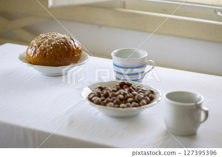 Enjoying traditional czech breakfast with sweet bread, hazelnuts and milk in Kourim 127395396