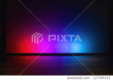 Empty stage illuminated with red and blue light reflecting on the floor 127395415