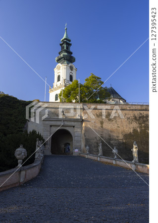 Nitra Castle entrance with statues and Saint Emmeram's Cathedral towering in the background, Slovakia Nitra Castle entrance with statues and Saint Emmeram's Cathedral towering in the background, Slovakia 127395423