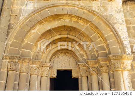 Romanesque archivolts decorating entrance of Santiago church in Aguero, Spain 127395498