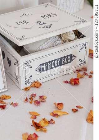 White wooden memory box for wedding with dried petals and lace inside White wooden memory box for wedding with dried petals and lace inside 127395511