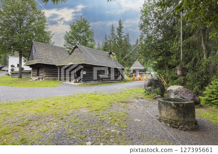 Museum of the Orava Village in Zuberec showing traditional wooden houses and stone well in Slovakia 127395661