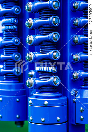 A close up of a bunch of blue springs on a green field 127395960