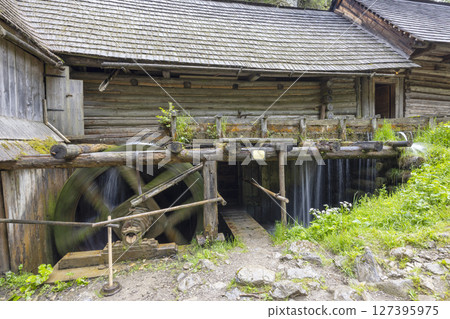 Old wooden watermill spinning near traditional slovak house in open air museum of Kvacany, Slovakia 127395975