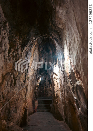 Rocky cave entrance in Marble Mountains with natural stairs, Scenic tunnel entrance leading into Marble Mountains in Vietnam Rocky cave entrance in Marble Mountains with natural stairs, Scenic tunnel entrance leading into Marble Mountains in Vietnam 127396228