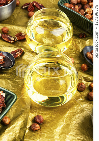 Aromatic nut oil bottle. Aromatic nut oil bottle. 127396378
