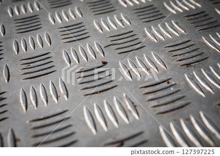 Close-Up of Textured Metal Tread Plate with Diamond Pattern for Industrial Flooring 127397225
