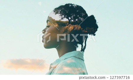 Double exposure of an indigenous woman with serene sky background Double exposure of an indigenous woman with serene sky background 127397716