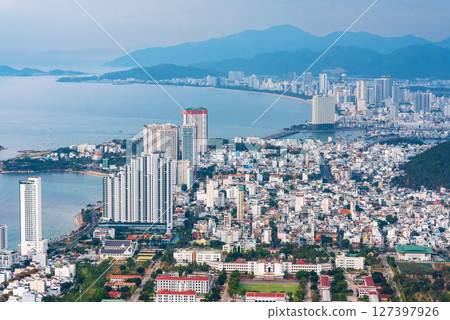 Panorama of Nha Trang city in Vietnam aerial view. Skyscrapers by the sea in resort town in Asia above of drone Panorama of Nha Trang city in Vietnam aerial view. Skyscrapers by the sea in resort town in Asia above of drone 127397926