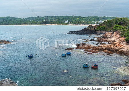 Landscape with Vietnamese basket boats in sea next to the rocks. Da Da reef or Ganh Da Dia in Vietnam. Aerial top view from drone 127397927