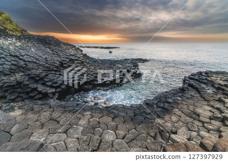 Da Dia reef or Ganh Da Dia in Phu Yen in Vietnam at sunrise. Landscape with volcanic basalt columns on rocky beach by sea Da Dia reef or Ganh Da Dia in Phu Yen in Vietnam at sunrise. Landscape with volcanic basalt columns on rocky beach by sea 127397929