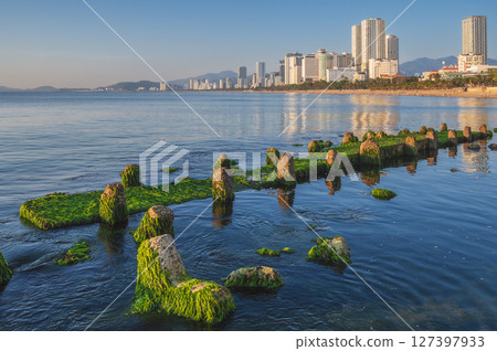 embankment and moss beach in Nha Trang city with skyscrapers in Vietnam embankment and moss beach in Nha Trang city with skyscrapers in Vietnam 127397933