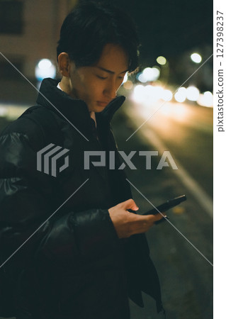 Night road, young man, smartphone Night road, young man, smartphone 127398237
