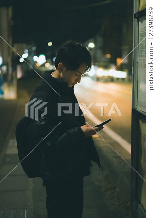 Night road, young man, smartphone Night road, young man, smartphone 127398239