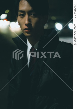 Man walking in the city at night 127398268