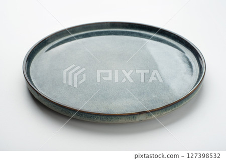 Empty textured plate on white background 127398532