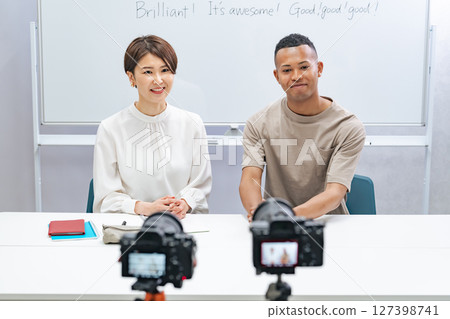 A black man and a Japanese woman filming a video 127398741