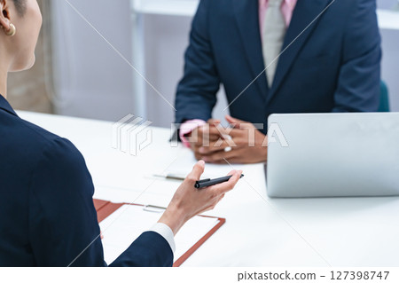 A Japanese female staff member interviewing a black male businessman 127398747