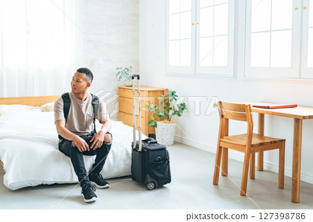 Black male traveler relaxing in a hotel room 127398786
