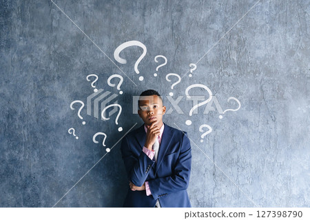A black male businessman worried in a dark room A black male businessman worried in a dark room 127398790