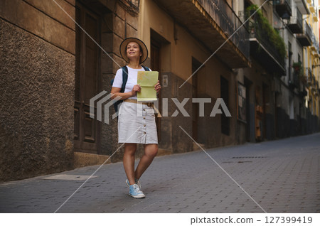 Woman Tourist Wandering Narrow Historic Streets Holding a Map Woman Tourist Wandering Narrow Historic Streets Holding a Map 127399419