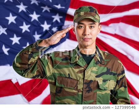 Asian american male soldier in uniform saluting on a background USA flag. 127399546
