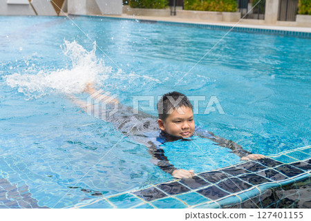 Teenage boy ready to swim in swimming pool Teenage boy ready to swim in swimming pool 127401155