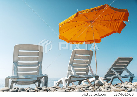 Sunny Beach with Loungers and Umbrella 127401566