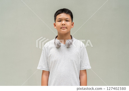 Thai Boy Portrait Against Plain Wall in Natural Light 127402380