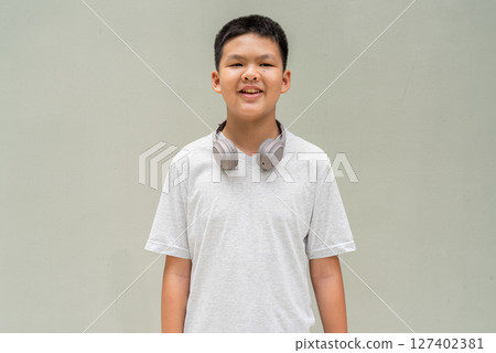 Thai Boy Portrait Against Plain Wall in Natural Light 127402381