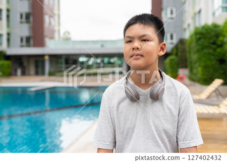 Teenage Boy at Poolside During Summer 127402432